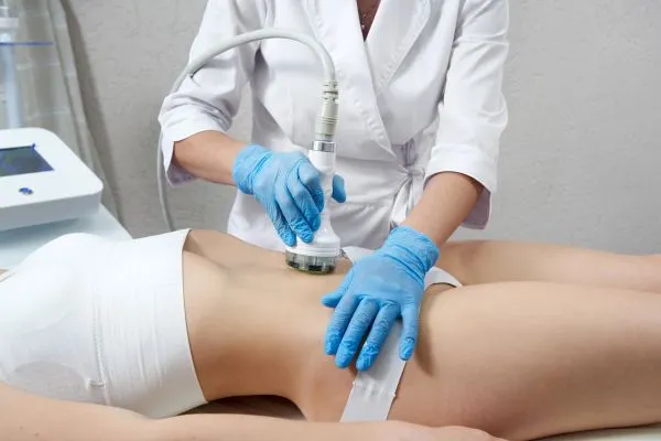 Lost the Weight but Not the Loose Skin? 2 woman having HIFU treatment on her stomach to combat loose skin Greenock following weight loss